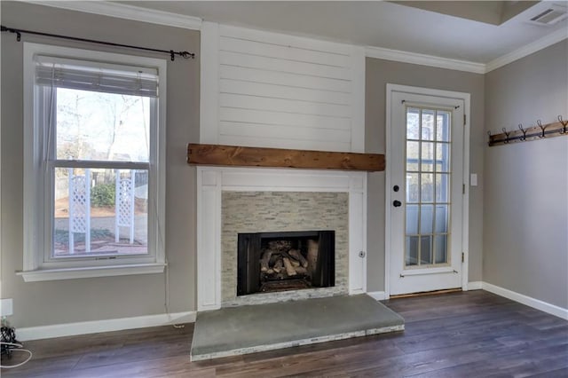 unfurnished living room with crown molding, a stone fireplace, and dark hardwood / wood-style flooring