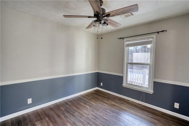 spare room featuring dark hardwood / wood-style floors and ceiling fan