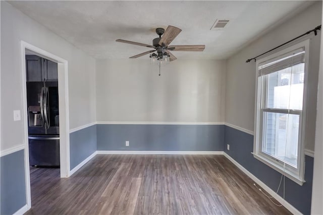 spare room with dark hardwood / wood-style floors and ceiling fan