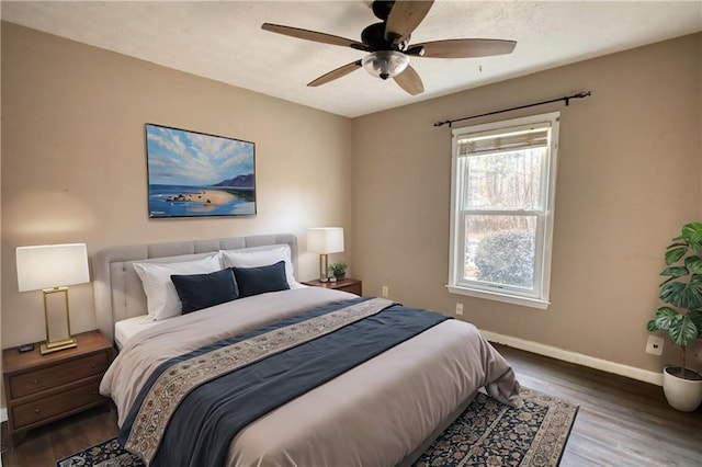 bedroom with dark hardwood / wood-style floors and ceiling fan