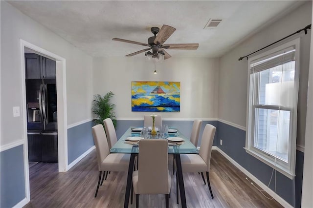 dining area featuring ceiling fan and dark hardwood / wood-style flooring