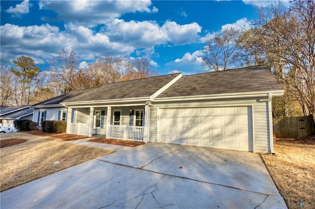 ranch-style house featuring a garage and covered porch