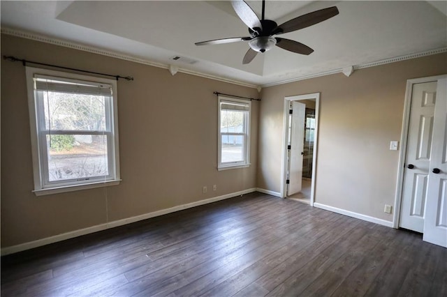 unfurnished bedroom featuring dark wood-type flooring, ceiling fan, connected bathroom, and multiple windows