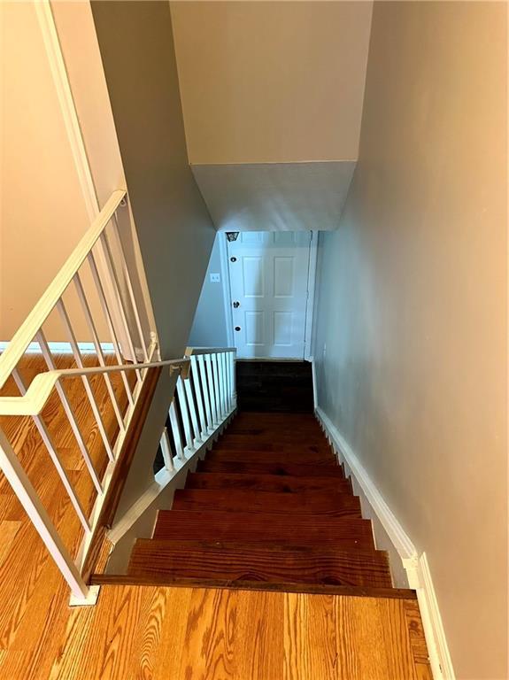 stairs featuring baseboards and wood finished floors
