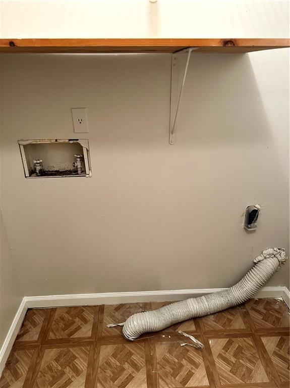 washroom with hookup for an electric dryer, baseboards, and hookup for a washing machine