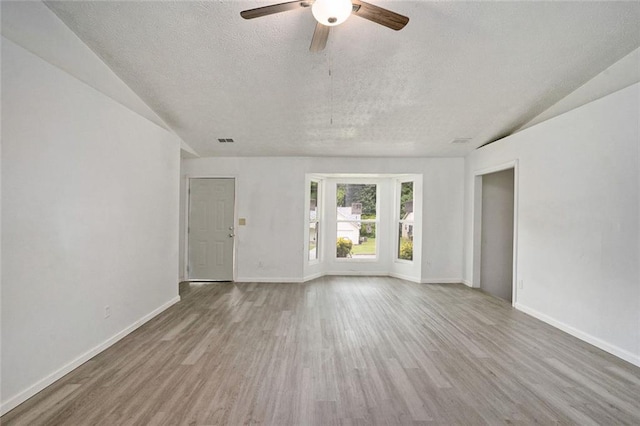 spare room featuring ceiling fan, wood-type flooring, and a textured ceiling