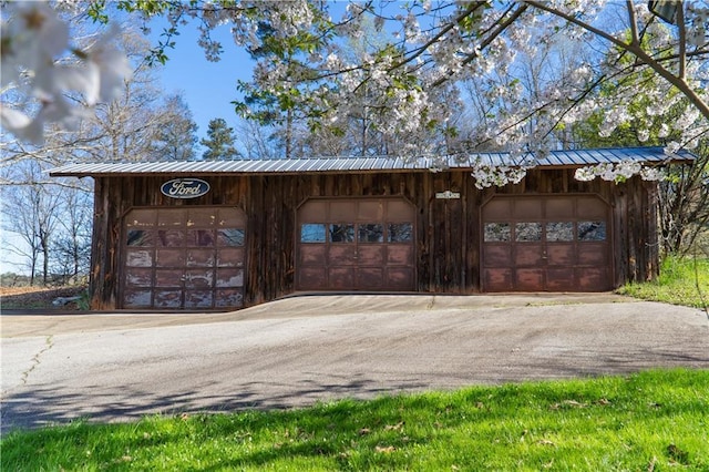 view of home's community with an outbuilding and a garage