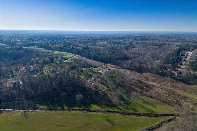 bird's eye view featuring a wooded view