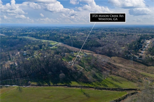 bird's eye view featuring a wooded view