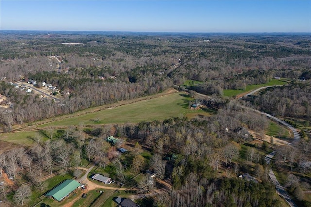 birds eye view of property with a wooded view