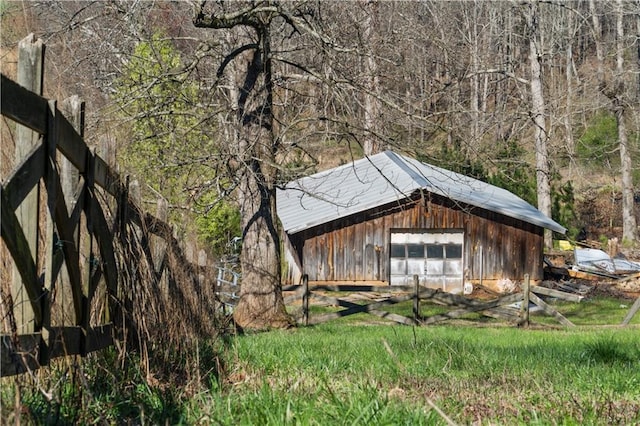 view of outdoor structure with an outbuilding and fence