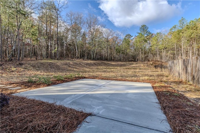 view of yard featuring basketball hoop