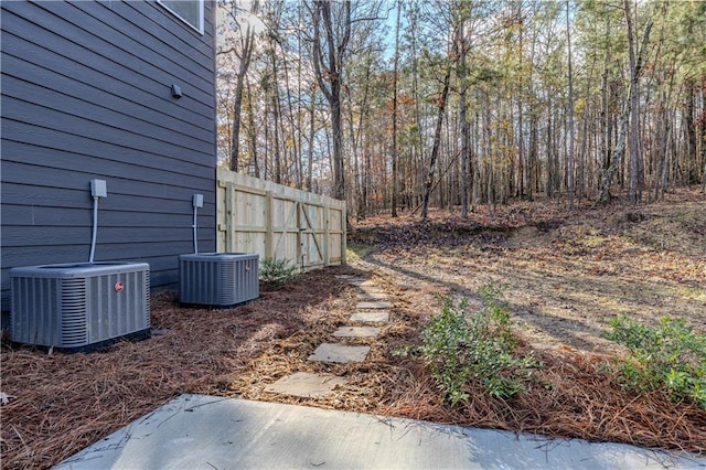 view of yard with central AC and a patio area