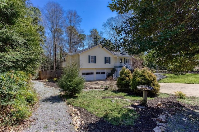 view of front of house featuring driveway, stairs, and a garage