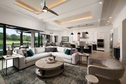 bedroom featuring an inviting chandelier, lofted ceiling, and light hardwood / wood-style flooring