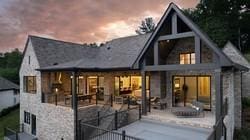 back house at dusk featuring a patio