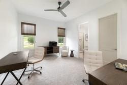 living room featuring a tray ceiling and ceiling fan