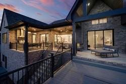 back house at dusk featuring a patio area
