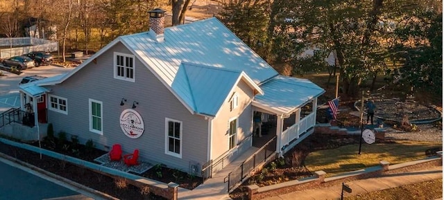 3350 Cranston Ln, Kennesaw, GA 30144 - view of home's exterior featuring metal roof and a chimney