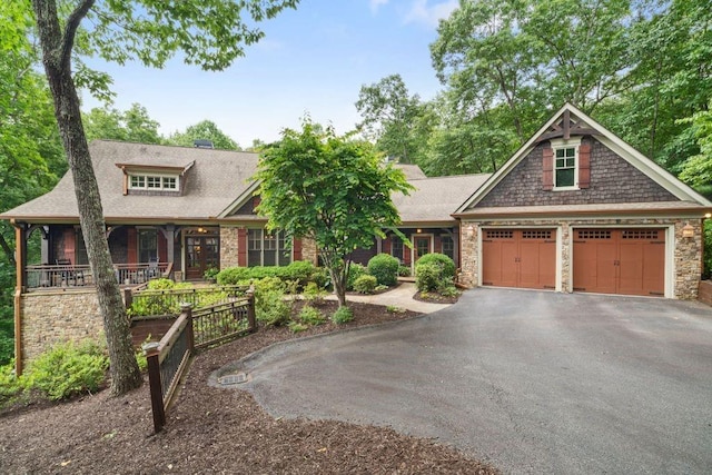 46 Bee Balm Way, Big Canoe, GA 30143 - craftsman inspired home featuring driveway, a porch, an attached garage, stone siding, and a shingled roof