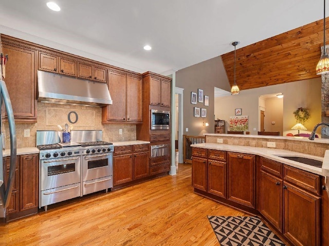 46 Bee Balm Way, Big Canoe, GA 30143 - kitchen with under cabinet range hood, stainless steel appliances, a warming drawer, light countertops, and vaulted ceiling