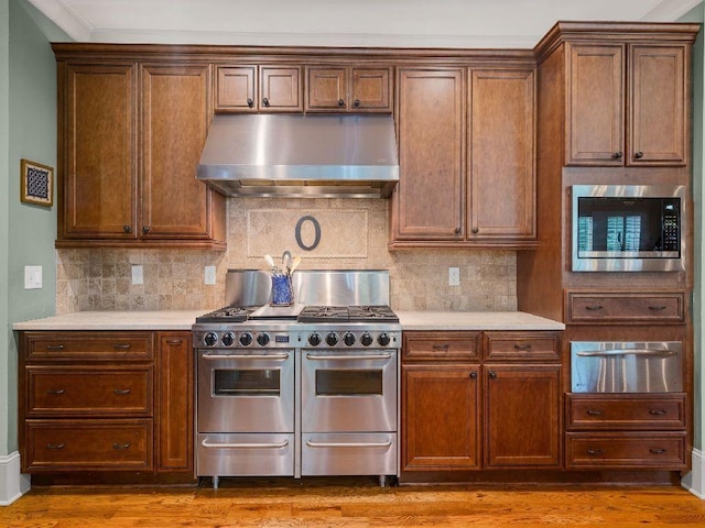46 Bee Balm Way, Big Canoe, GA 30143 - kitchen featuring range hood, stainless steel appliances, a warming drawer, and light countertops