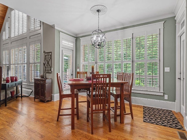 46 Bee Balm Way, Big Canoe, GA 30143 - dining area featuring a chandelier, healthy amount of natural light, wood finished floors, and ornamental molding
