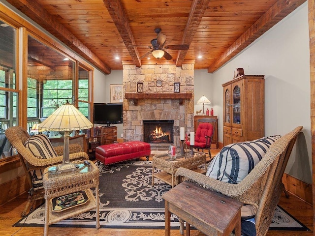 46 Bee Balm Way, Big Canoe, GA 30143 - living area featuring a wooden ceiling with exposed beams, a ceiling fan, wood finished floors, and a stone fireplace