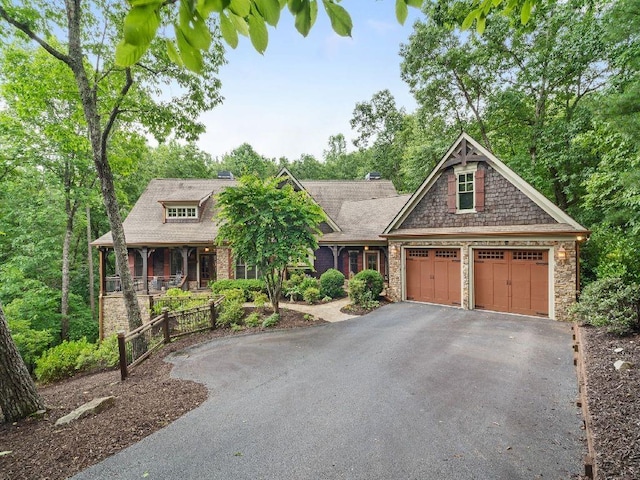46 Bee Balm Way, Big Canoe, GA 30143 - view of front of home with asphalt driveway, stone siding, and covered porch