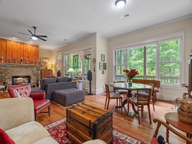 46 Bee Balm Way, Big Canoe, GA 30143 - living area featuring ornamental molding, ceiling fan, plenty of natural light, light wood finished floors, and a fireplace