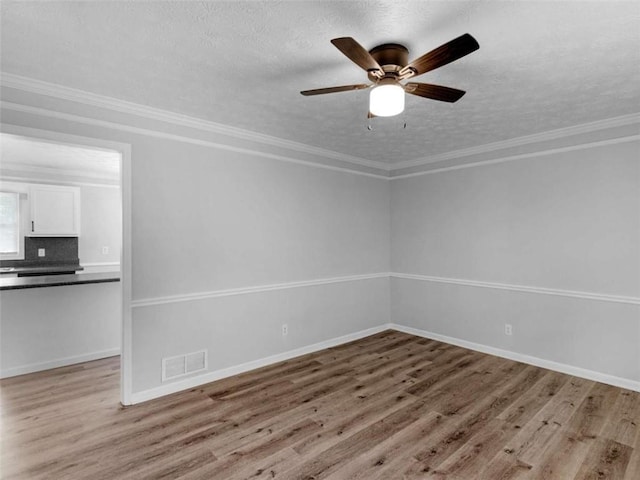 4720 Hull Rd, Conyers, GA 30094 - spare room with wood finished floors, a textured ceiling, ceiling fan, and crown molding