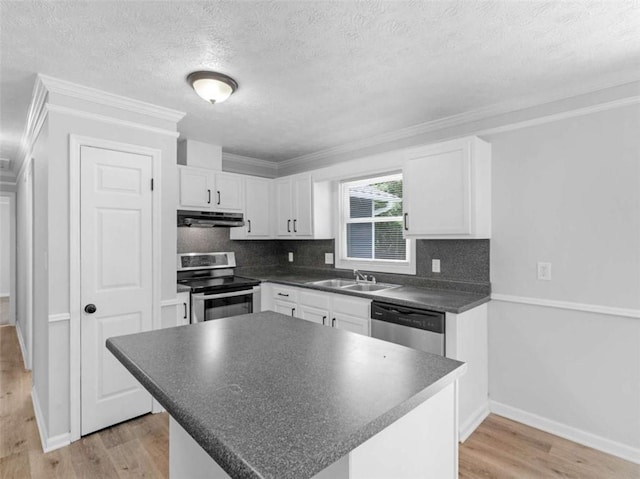 4720 Hull Rd, Conyers, GA 30094 - kitchen featuring stainless steel appliances, under cabinet range hood, dark countertops, light wood-style flooring, and white cabinets