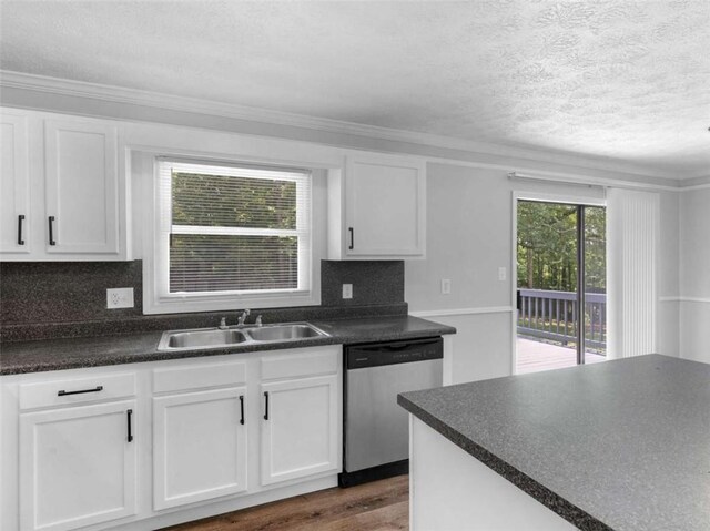 4720 Hull Rd, Conyers, GA 30094 - kitchen with stainless steel dishwasher, dark countertops, a textured ceiling, white cabinets, and dark wood-style floors