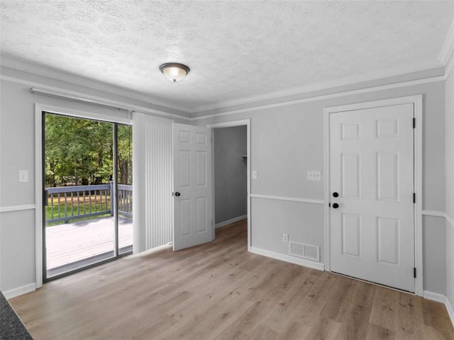 4720 Hull Rd, Conyers, GA 30094 - empty room with a textured ceiling, wood finished floors, and crown molding