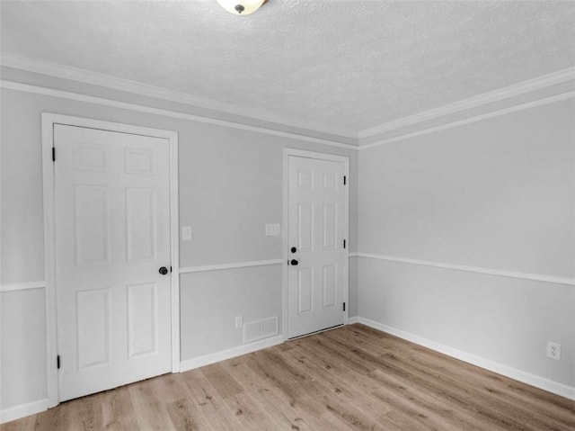 4720 Hull Rd, Conyers, GA 30094 - foyer entrance with wood finished floors, a textured ceiling, and ornamental molding