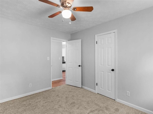 4720 Hull Rd, Conyers, GA 30094 - unfurnished bedroom with a textured ceiling, carpet floors, and a ceiling fan