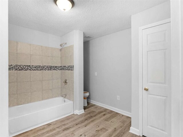 4720 Hull Rd, Conyers, GA 30094 - full bathroom featuring shower / bathtub combination, wood finished floors, and a textured ceiling
