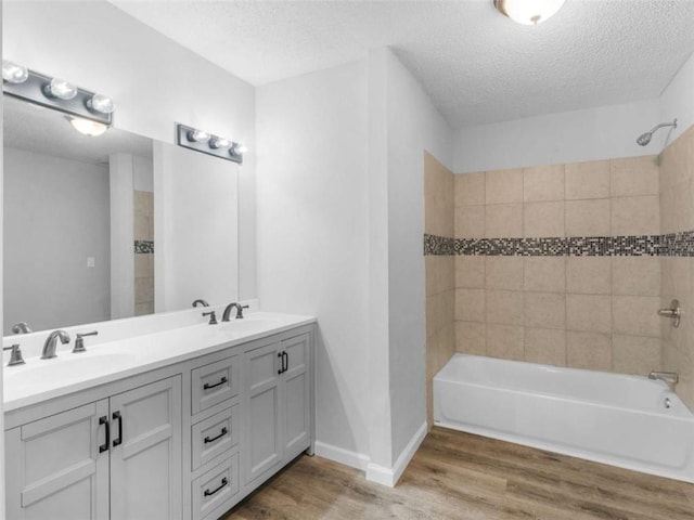 4720 Hull Rd, Conyers, GA 30094 - full bath featuring wood finished floors, double vanity, shower / washtub combination, and a textured ceiling