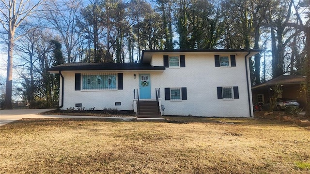 split level home with crawl space, a front yard, and brick siding