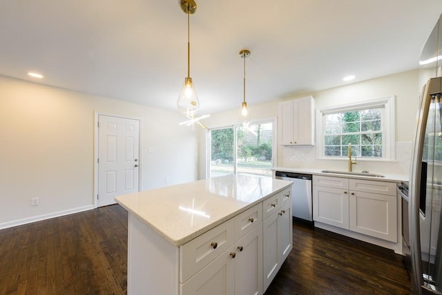 kitchen with dark wood-style floors, dishwasher, a kitchen island, and a sink