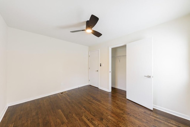 unfurnished bedroom with visible vents, baseboards, a closet, and dark wood-style flooring