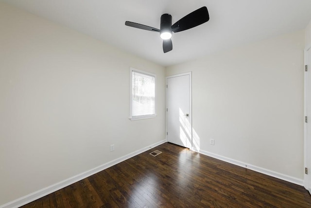 unfurnished room featuring a ceiling fan, visible vents, wood finished floors, and baseboards