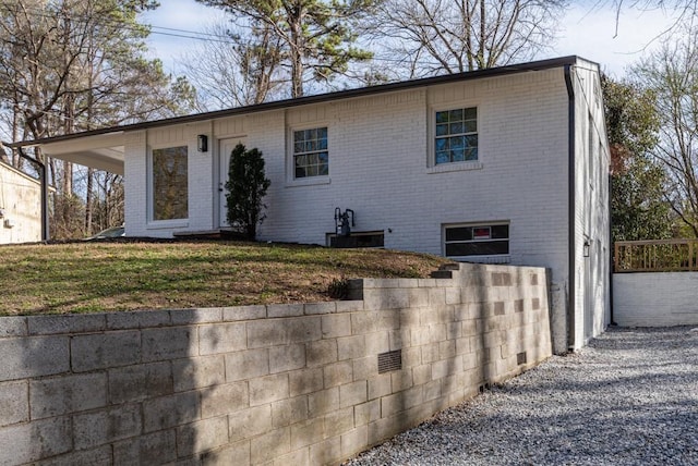 view of front facade featuring brick siding and fence