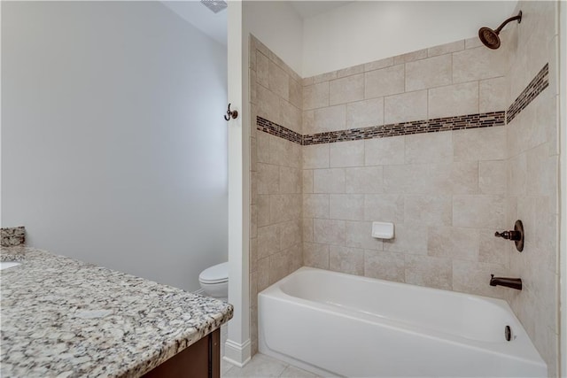 full bathroom featuring vanity, tile patterned floors, toilet, and tiled shower / bath