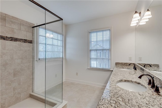 bathroom with vanity, a healthy amount of sunlight, tile patterned floors, and walk in shower