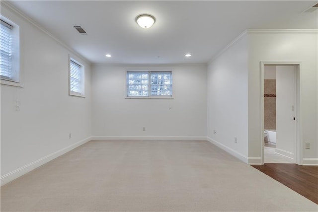 spare room featuring crown molding and wood-type flooring