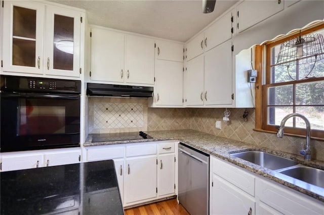 kitchen featuring sink, white cabinetry, and black appliances