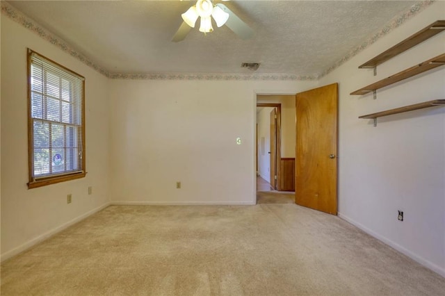 carpeted empty room with ceiling fan