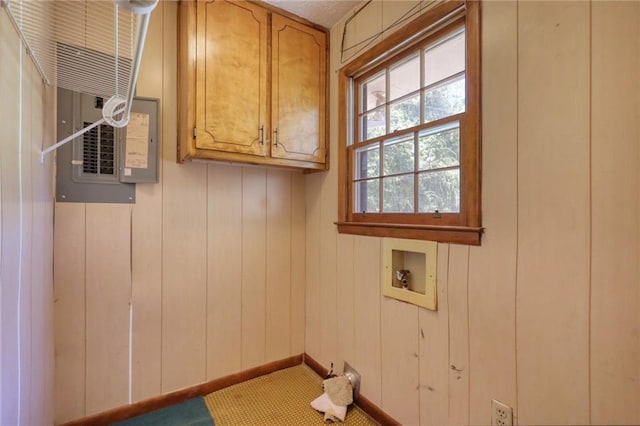 laundry area featuring wood walls, cabinets, and hookup for a washing machine