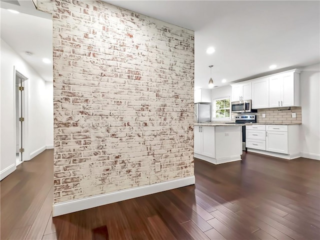 644 Albert St NW, Atlanta, GA 30318 - kitchen with appliances with stainless steel finishes, dark wood-style flooring, white cabinetry, a kitchen island, and recessed lighting